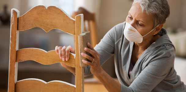 10 uses for sandpaper woman sanding paint off a wood chair