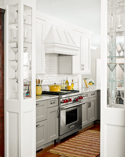kitchen after redo with storage cabinets around entry to formal dining room with glass upper panels for display
