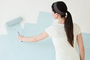 DIY calorie burners woman painting a wall