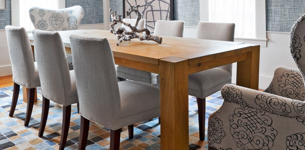 blocky, modern dining room table with gray fabric chairs a large yellow box ceiling fixture and linen-look wallpaper to illustrate the Designers' Favorite Basics gallery
