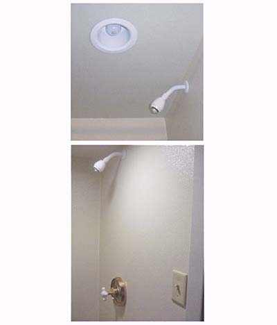 home inspection photo of unprotected light bulb and switch in shower