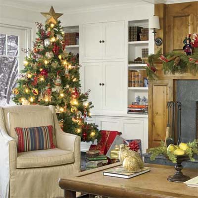Christmas tree in front of custom built=in cabinets flanking fireplace