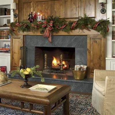 hearth with new knotty alder mantel and paneling and soapstone surround in this remodeled shingle-style cottage