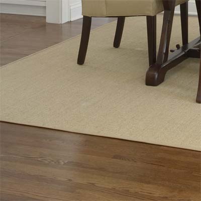old and new planks were interlaced with the existing red oak floor and finished with a walnut stain in this remodeled shingle-style cottage