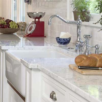 glossy white subway tiles used in this remodeled shingle-style cottage