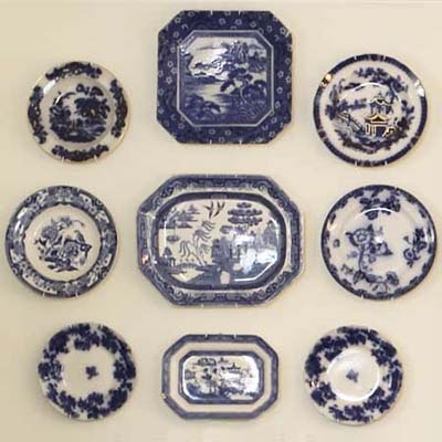 vintage plates used to personalize the space in this remodeled shingle-style cottage