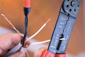 man cutting electrical wire
