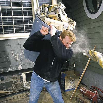 man cleaning up trash on job site