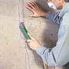 cleaning the crack with a wire brush