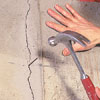 tapping finish nails into the crack