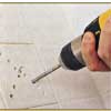 Choosing the right location and drilling holes into the tile for removal