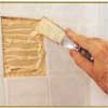 Applying tile adhesive with a putty knife
