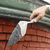 mixing mortar to apply to a brick wall