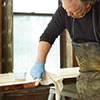 John Thomas tests the finish on the door edge