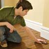 sanding a wood floor with a sanding sponge