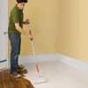 painting the base coat onto a wooden floor