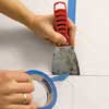 cutting painter's tape with a putty knife