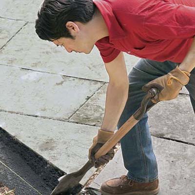 Shovel Stone Dust into Trench