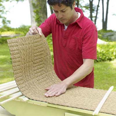 man attaching a non slip rug to the lid of the pet ramp
