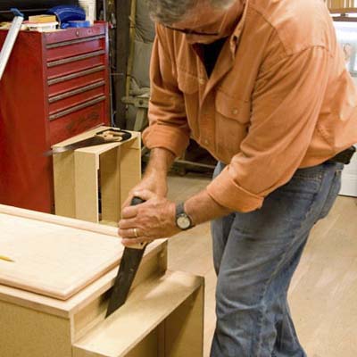 Tom Silva removing a toekick from a stock cabinet