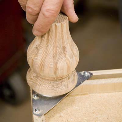 Tom Silva screwing feet into the foot plates