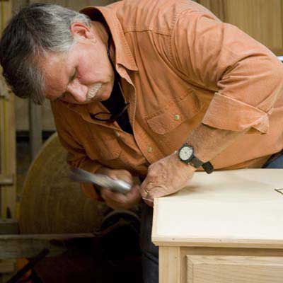 Tom Silva adding the trim to the top of the sideboard