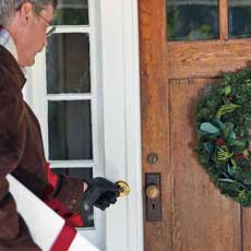 man approaching front door to ring the doorbell