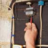 electrician testing doorbell transformer with multimeter