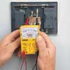 man testing an electrical doorbell chime with a multimeter