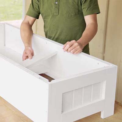 hands installing the bottom boards of this all weather planter