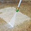 pressure-washing the concrete walkway to prepare for resurfacing