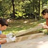 man and woman attaching bottom of window box frame