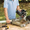 man using a miter saw
