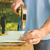 man using nail and hammer