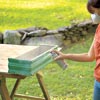 woman sealing window box finish