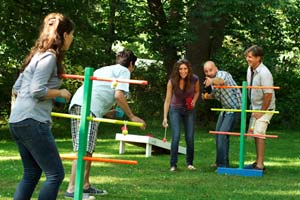 men and women playing ladder golf yard game