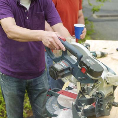 Man cutting jig pieces 
