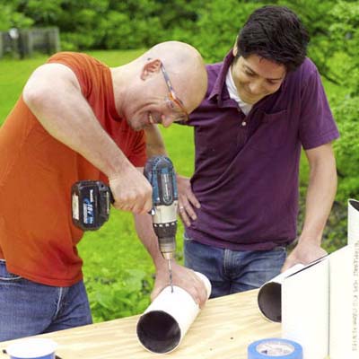 Man drilling holes into a pipe