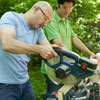 men using miter saw to cut kubb pieces