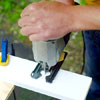 people cutting the slit for the elastic band while building a ricochet game board