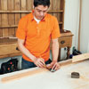 Mark Powers marks notch locations on the leg pieces of a bar cart