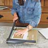 woman trims photo mat to size  