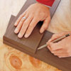 marking a cut line on board with a pencil 