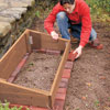 installing pavers around the the cold frame area as a stable foundation