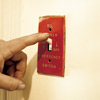 man turning off electrical power for furnace repair