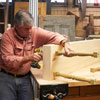 Tom Silva screwing spindles to the base of the shelving unit