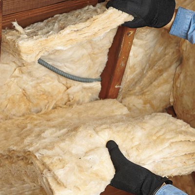 man installing batt insulation