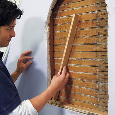 man installing additional padding for wall niche installation