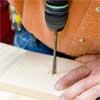 this old house general contractor drilling the holes for the wire while building a freestanding lamp
