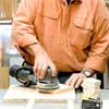 this old house general contractor sanding and painting the pieces to build a freestanding lamp